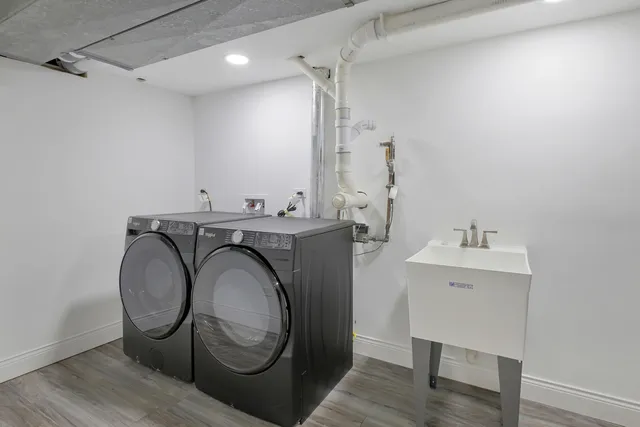 a utility room with sink dryer and washer