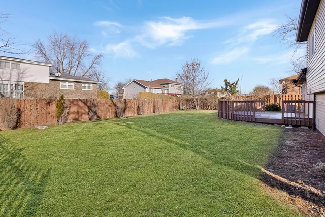 a view of an house with backyard space and deck