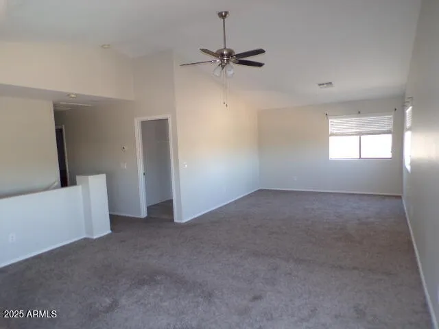 a view of a room with window and a ceiling fan