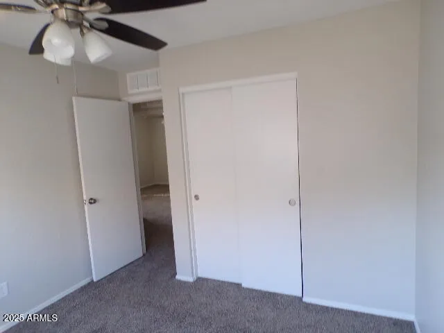 a view of a room with a ceiling fan