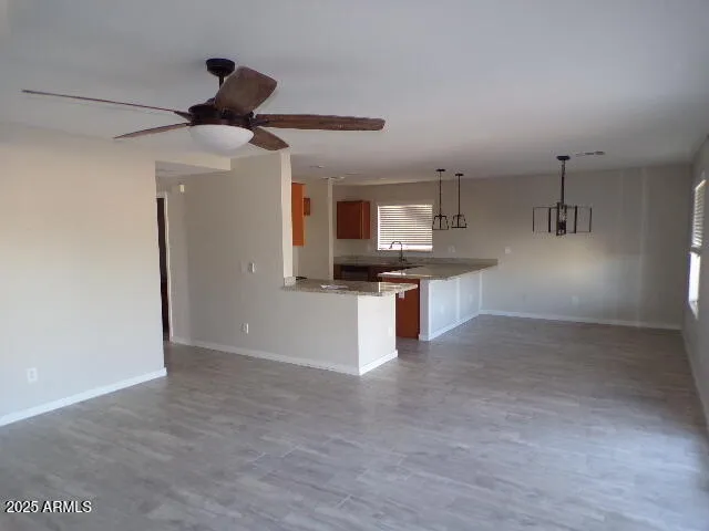 a kitchen with stainless steel appliances kitchen island granite countertop a refrigerator and a sink