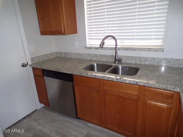 a kitchen with granite countertop a sink and cabinets