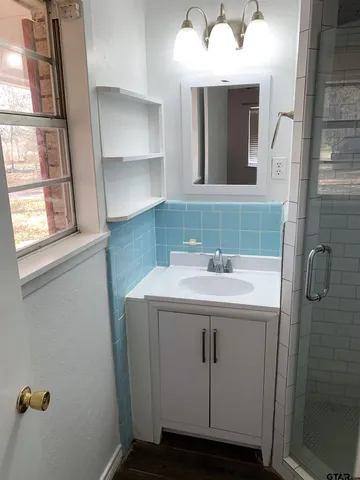a bathroom with a sink and mirror