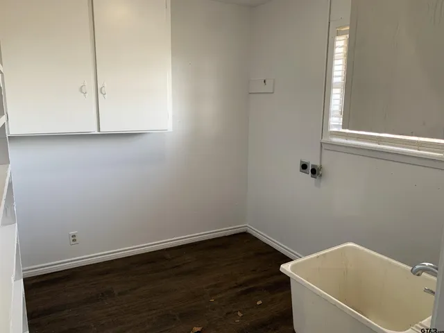 a view of a room with wooden floor and white walls