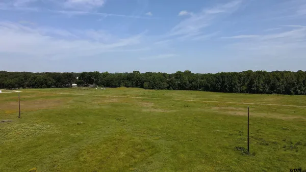 a view of a field with an ocean