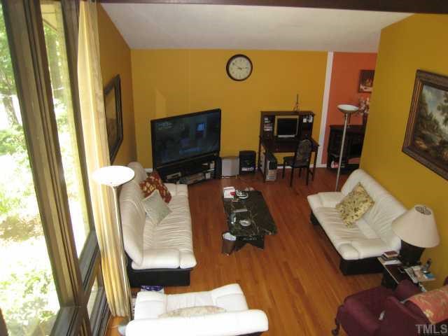 4612 Fernham Place Raleigh, NC 27612 - Photo 2 of 8 a living room with furniture and a flat screen tv