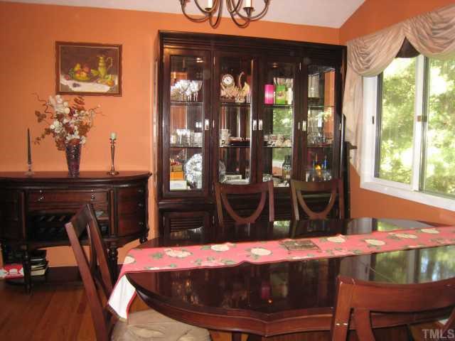 4612 Fernham Place Raleigh, NC 27612 - Photo 3 of 8 a view of a dining room with furniture window and wooden floor