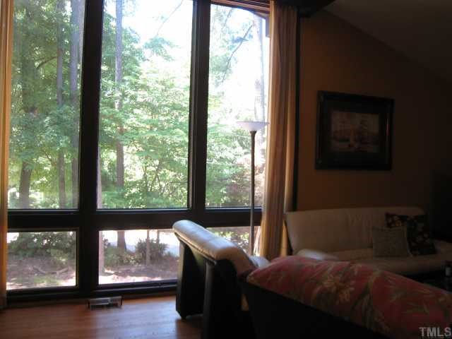 4612 Fernham Place Raleigh, NC 27612 - Photo 4 of 8 a bedroom with a bed window and wooden floor