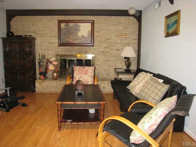 4612 Fernham Place Raleigh, NC 27612 - Photo 6 of 8 a living room with a couch and a fireplace
