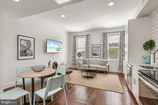 a living room with furniture and floor to ceiling windows