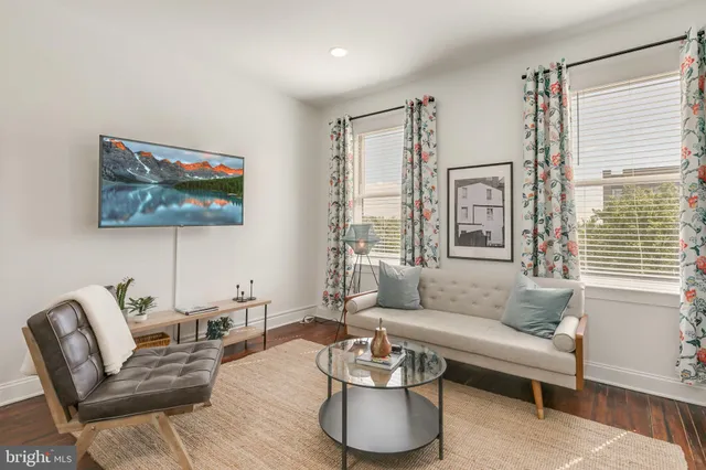 a living room with furniture and a large window