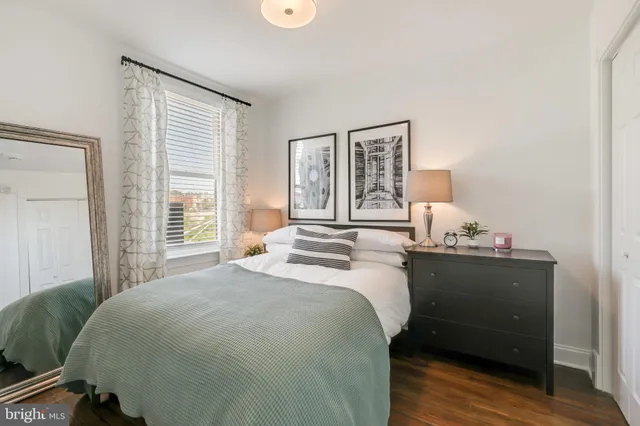 a bed room with a bed and a window