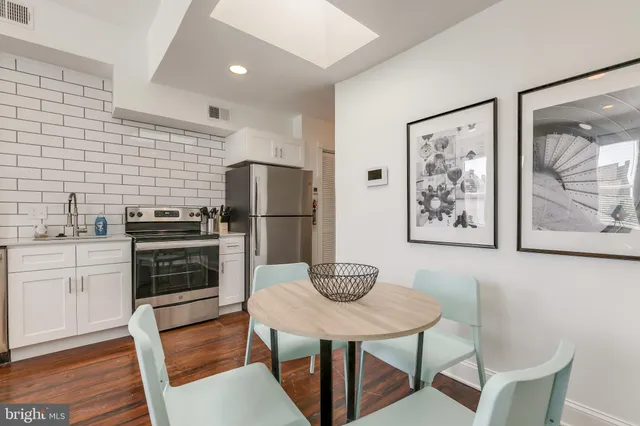 a kitchen with stainless steel appliances a refrigerator and a stove top oven
