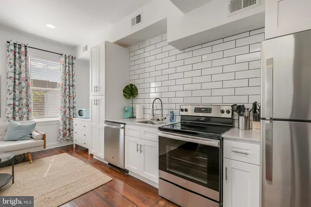 a kitchen with a stove a sink and a refrigerator