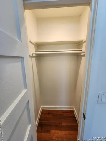 a view of walk in closet with empty racks