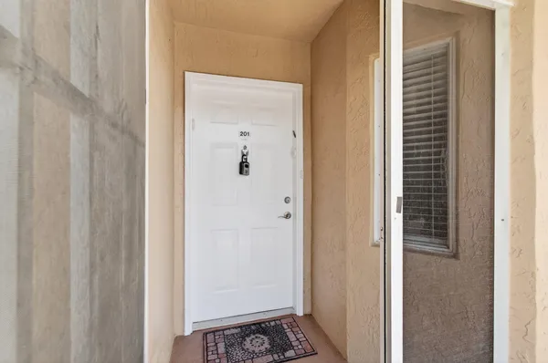 a view of a hallway with wooden floor and stairs