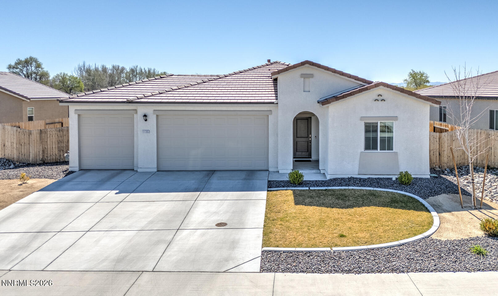 1135 Tamarack Drive Fallon, NV 89406 - Photo 1 of 23 a view of a white house with swimming pool in front of it