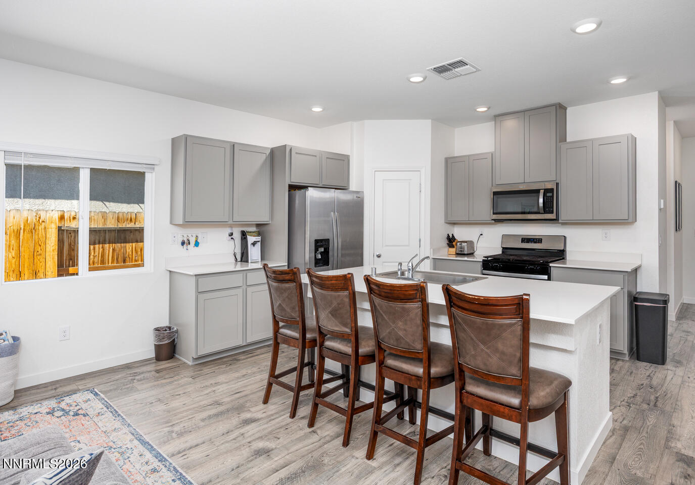 1135 Tamarack Drive Fallon, NV 89406 - Photo 6 of 23 a kitchen with stainless steel appliances a refrigerator and a stove top oven