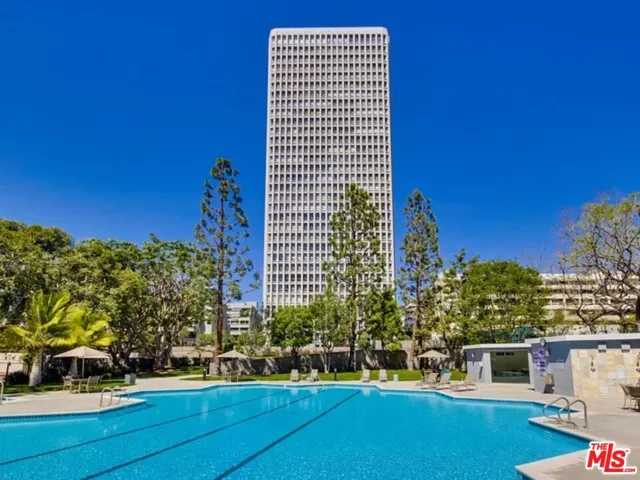 a front view of a building with trees