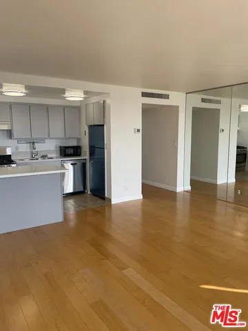 a view of a balcony with two chairs and a barbeque