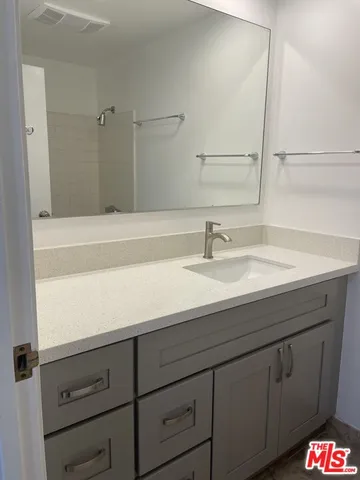 a view of a yard with plants and a fountain