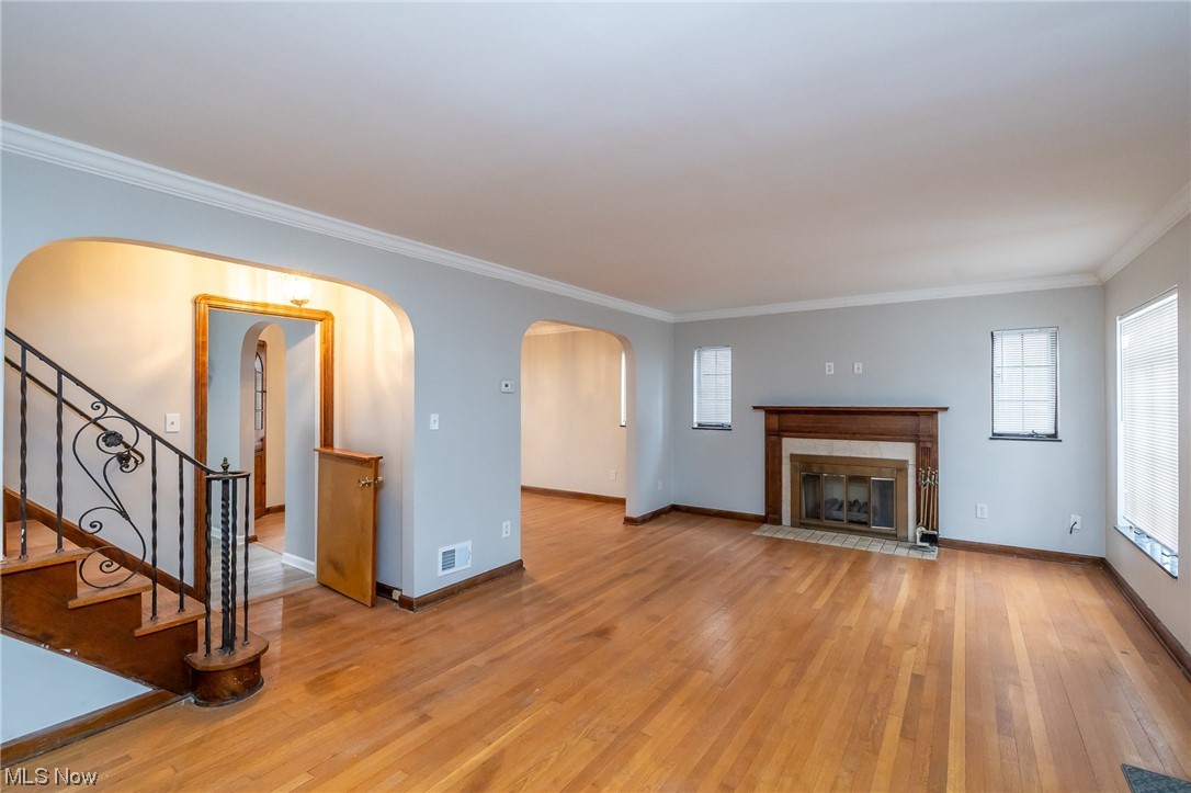 4668 Broadale Road Cleveland, OH 44109 - Photo 15 of 25 Unfurnished living room with ornamental molding and light hardwood / wood-style floors
