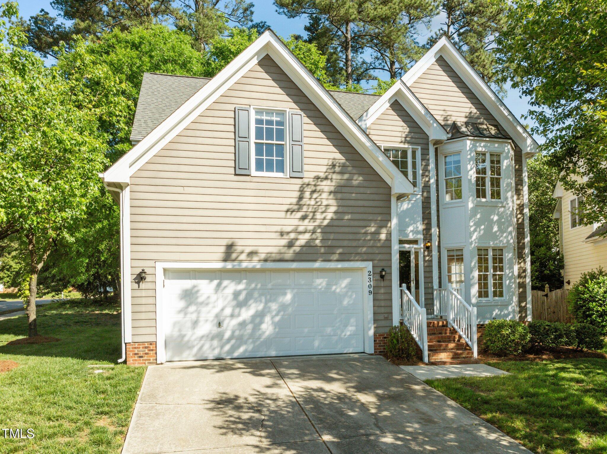 2309 Clerestory Place Raleigh, NC 27615 - Photo 1 of 37 a view of a house with yard and a garden