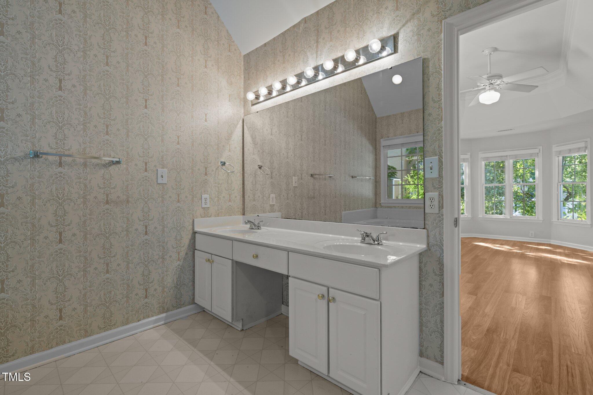 2309 Clerestory Place Raleigh, NC 27615 - Photo 19 of 37 a spacious bathroom with a granite countertop sink a large mirror and a shower
