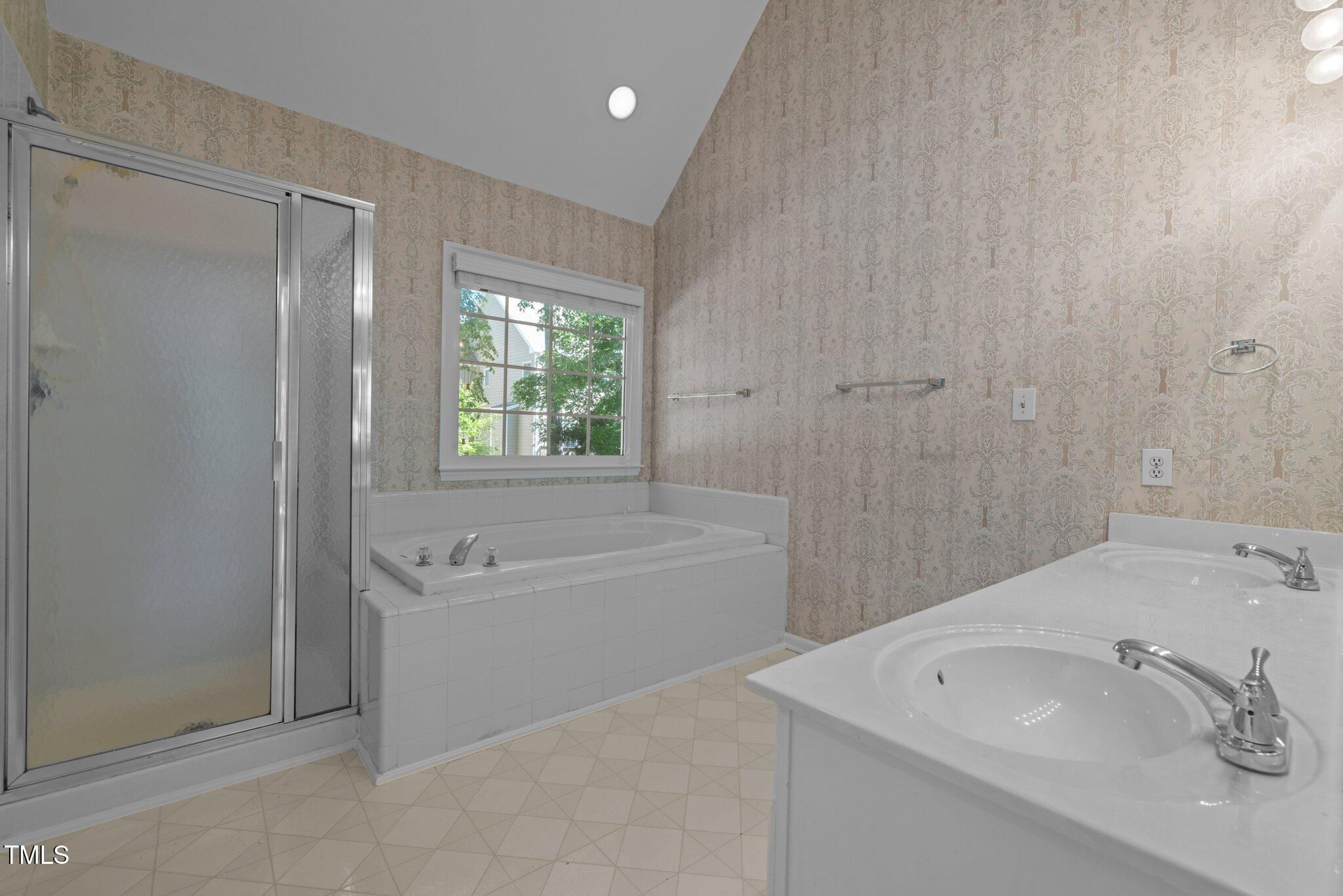 2309 Clerestory Place Raleigh, NC 27615 - Photo 20 of 37 a bathroom with a tub sink and a shower