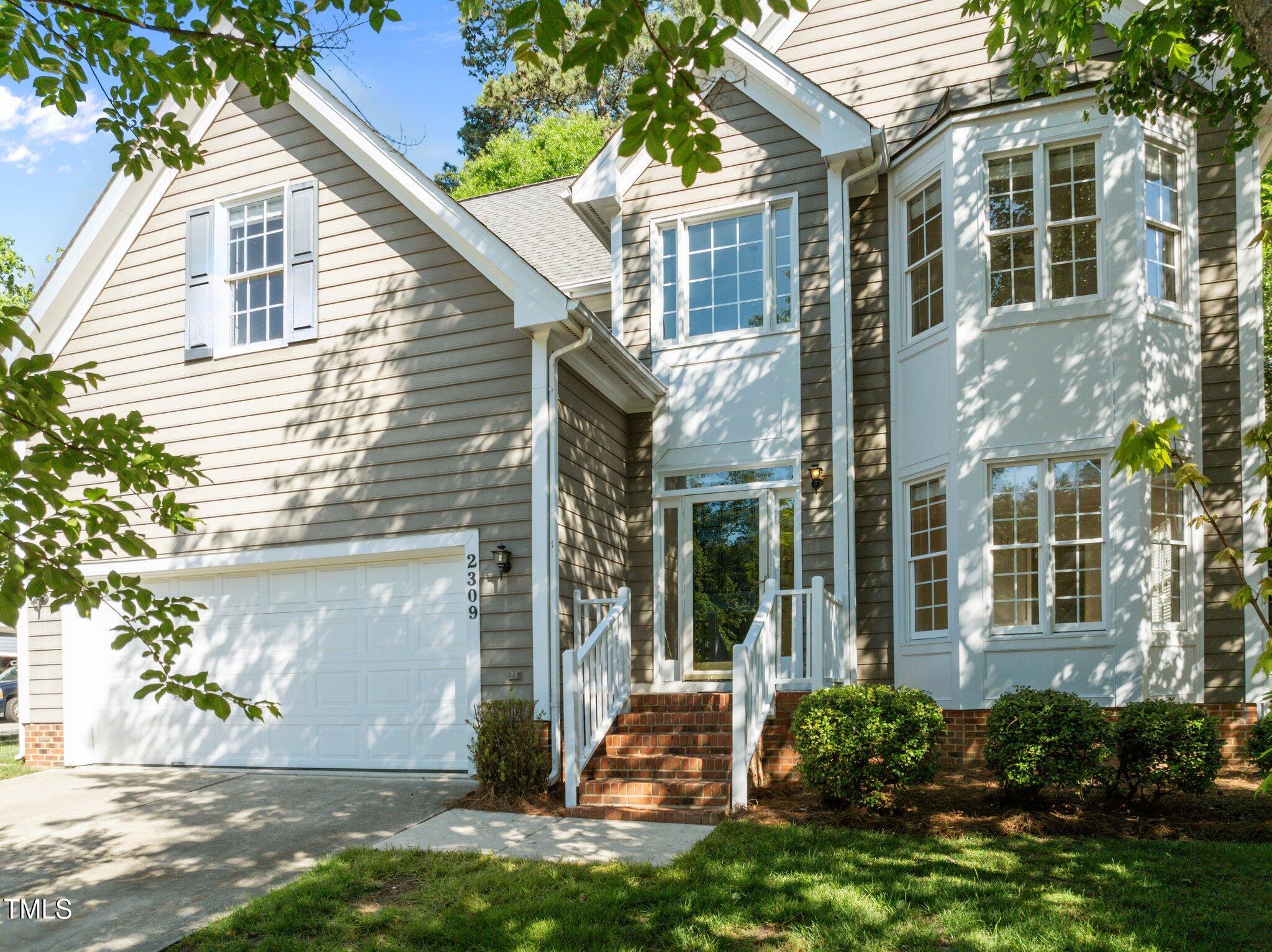 2309 Clerestory Place Raleigh, NC 27615 - Photo 2 of 37 a view of a house with a yard