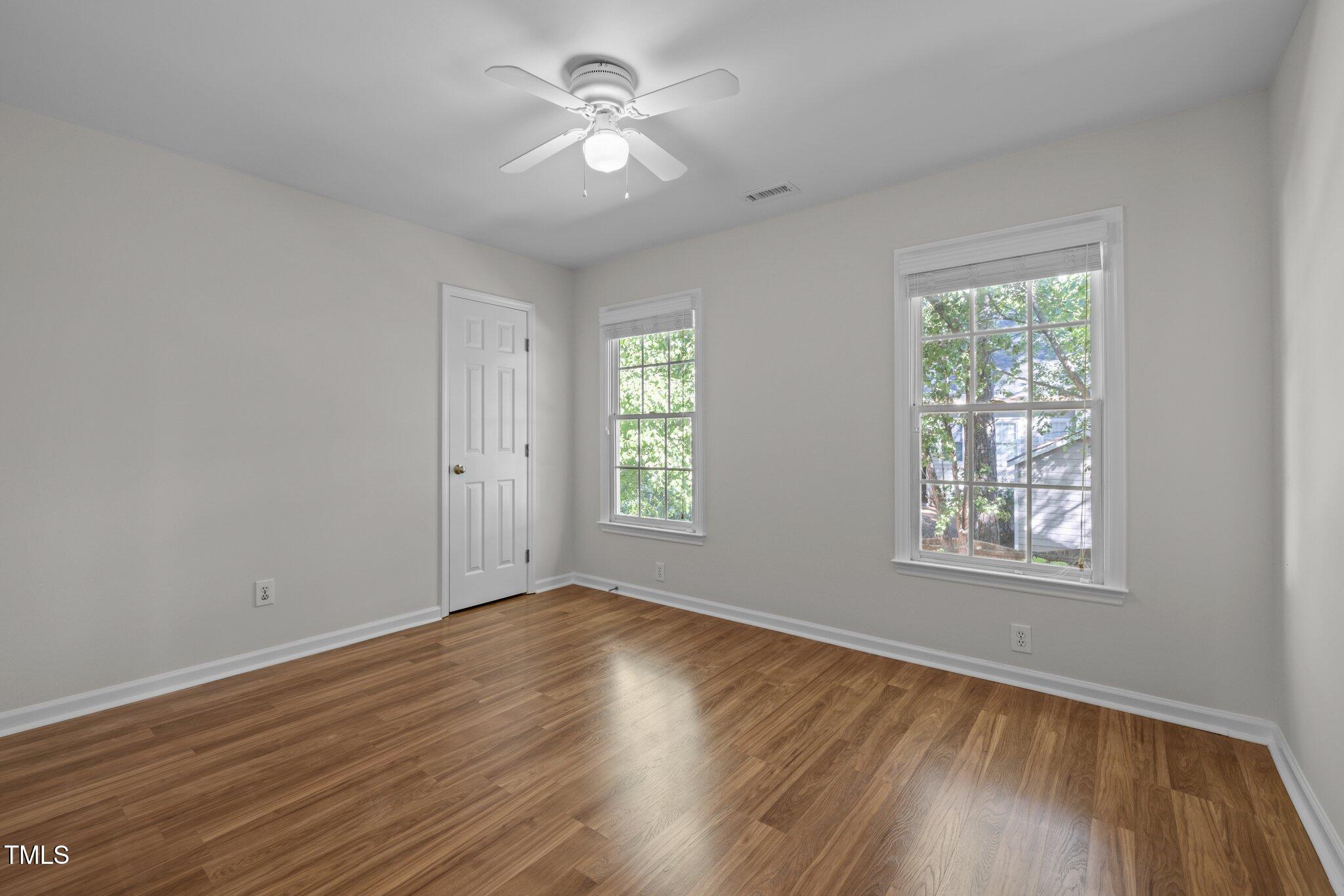 2309 Clerestory Place Raleigh, NC 27615 - Photo 23 of 37 a view of an empty room with a window and wooden floor