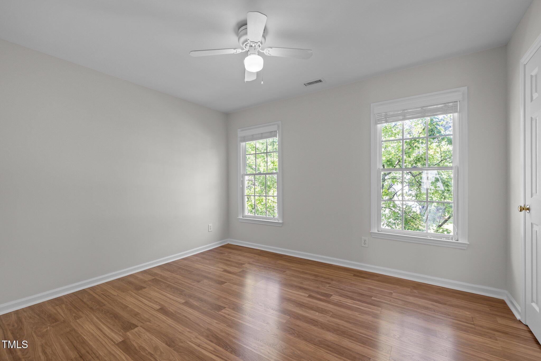 2309 Clerestory Place Raleigh, NC 27615 - Photo 24 of 37 a view of an empty room with a window and wooden floor