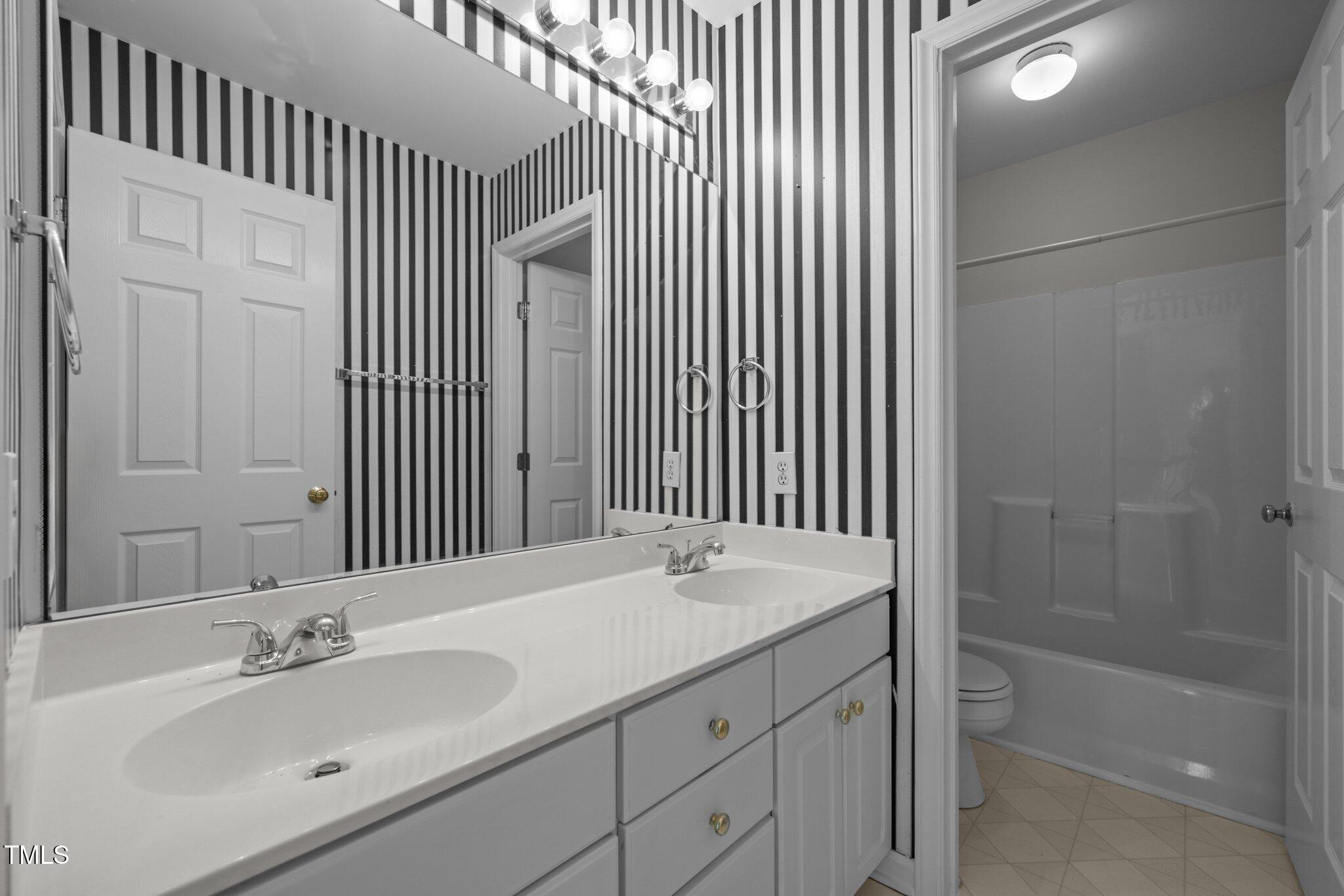 2309 Clerestory Place Raleigh, NC 27615 - Photo 25 of 37 a bathroom with a sink and a mirror