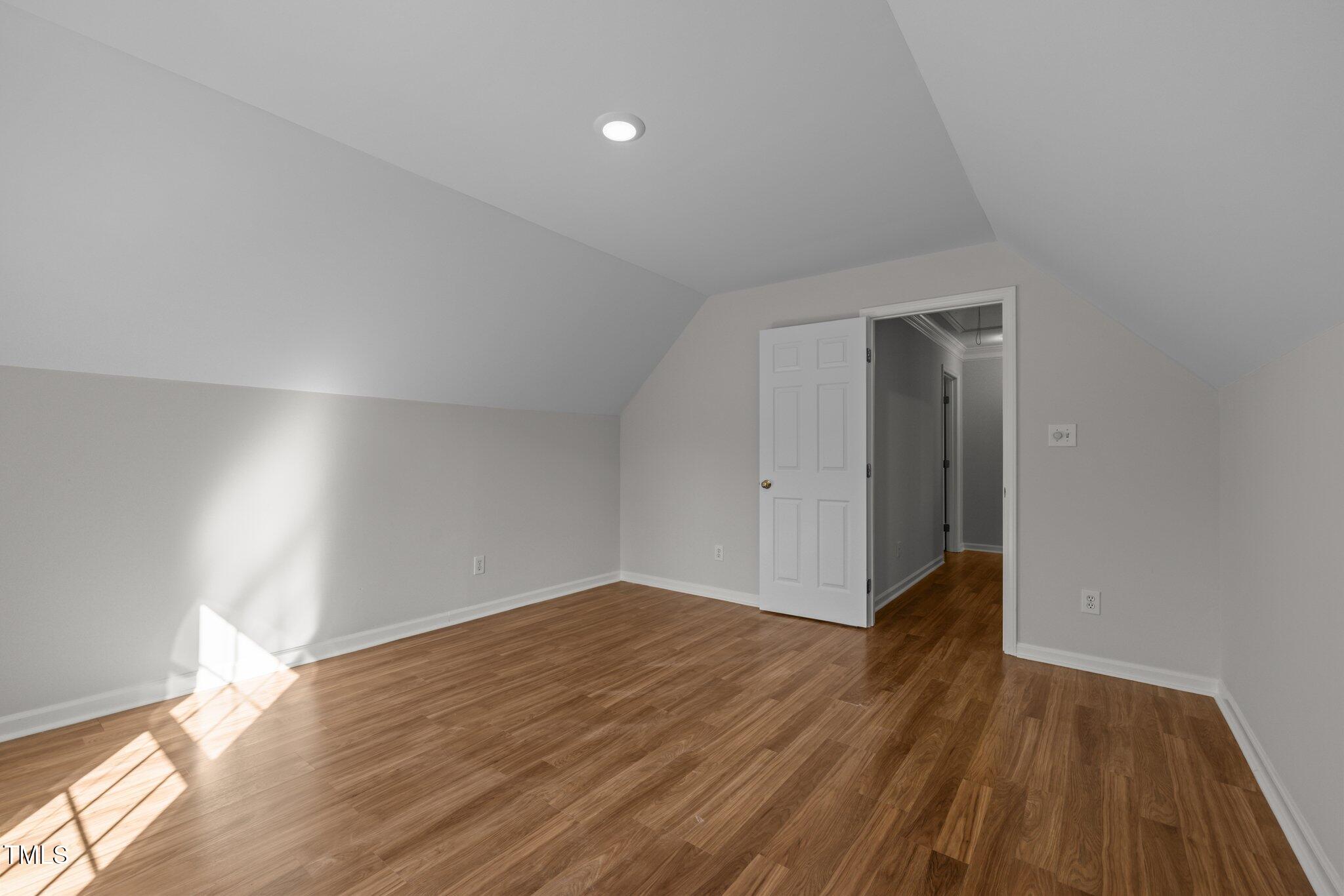 2309 Clerestory Place Raleigh, NC 27615 - Photo 27 of 37 a view of an empty room with wooden floor and a window