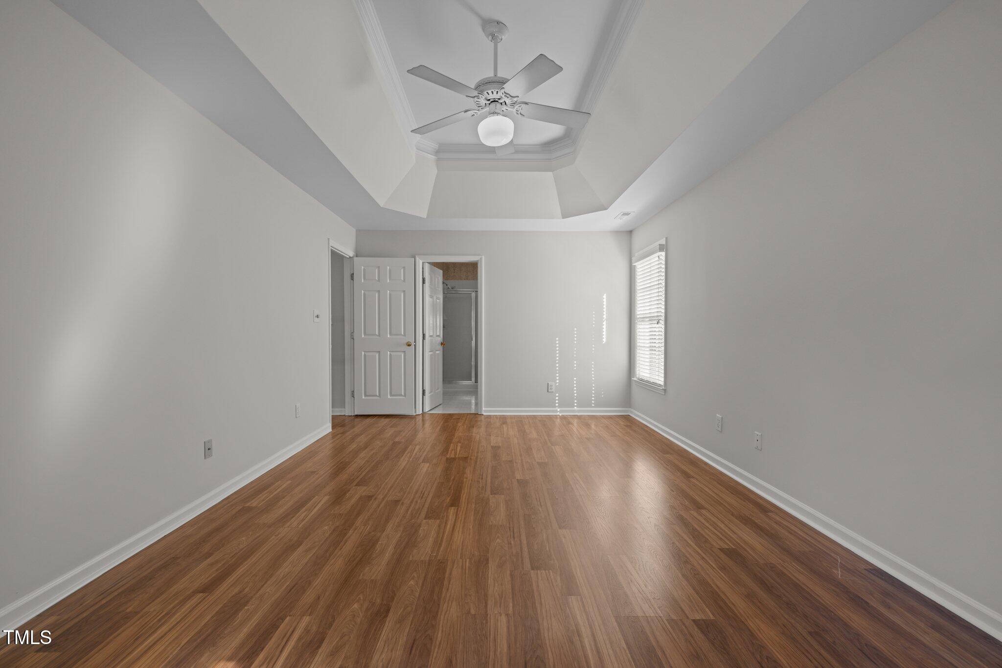 2309 Clerestory Place Raleigh, NC 27615 - Photo 28 of 37 a view of an empty room with wooden floor and a window