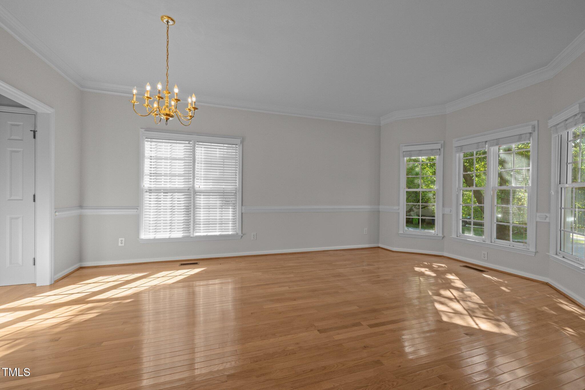 2309 Clerestory Place Raleigh, NC 27615 - Photo 4 of 37 a view of an empty room with a window and a kitchen