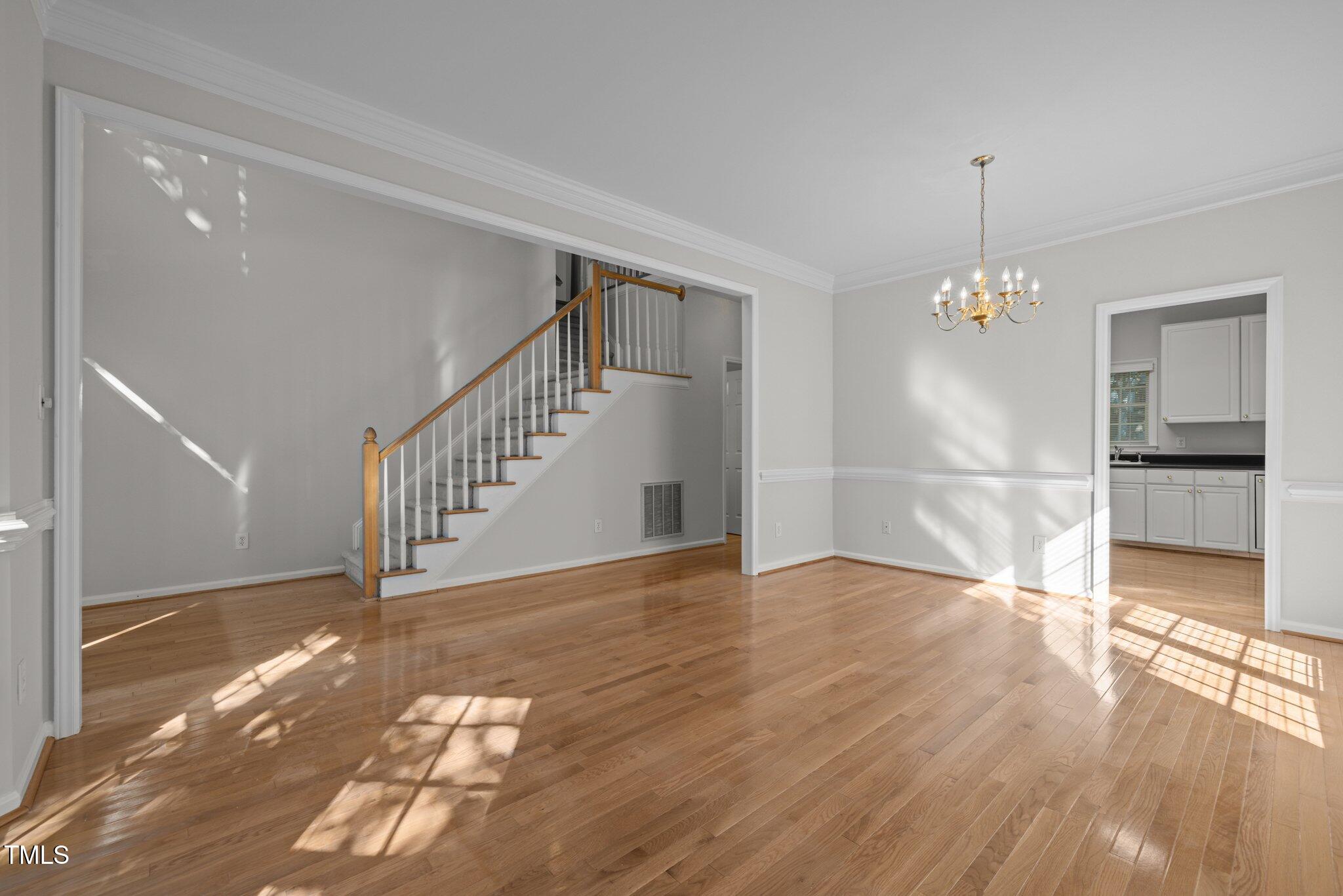 2309 Clerestory Place Raleigh, NC 27615 - Photo 5 of 37 a view of empty room with wooden floor and fan