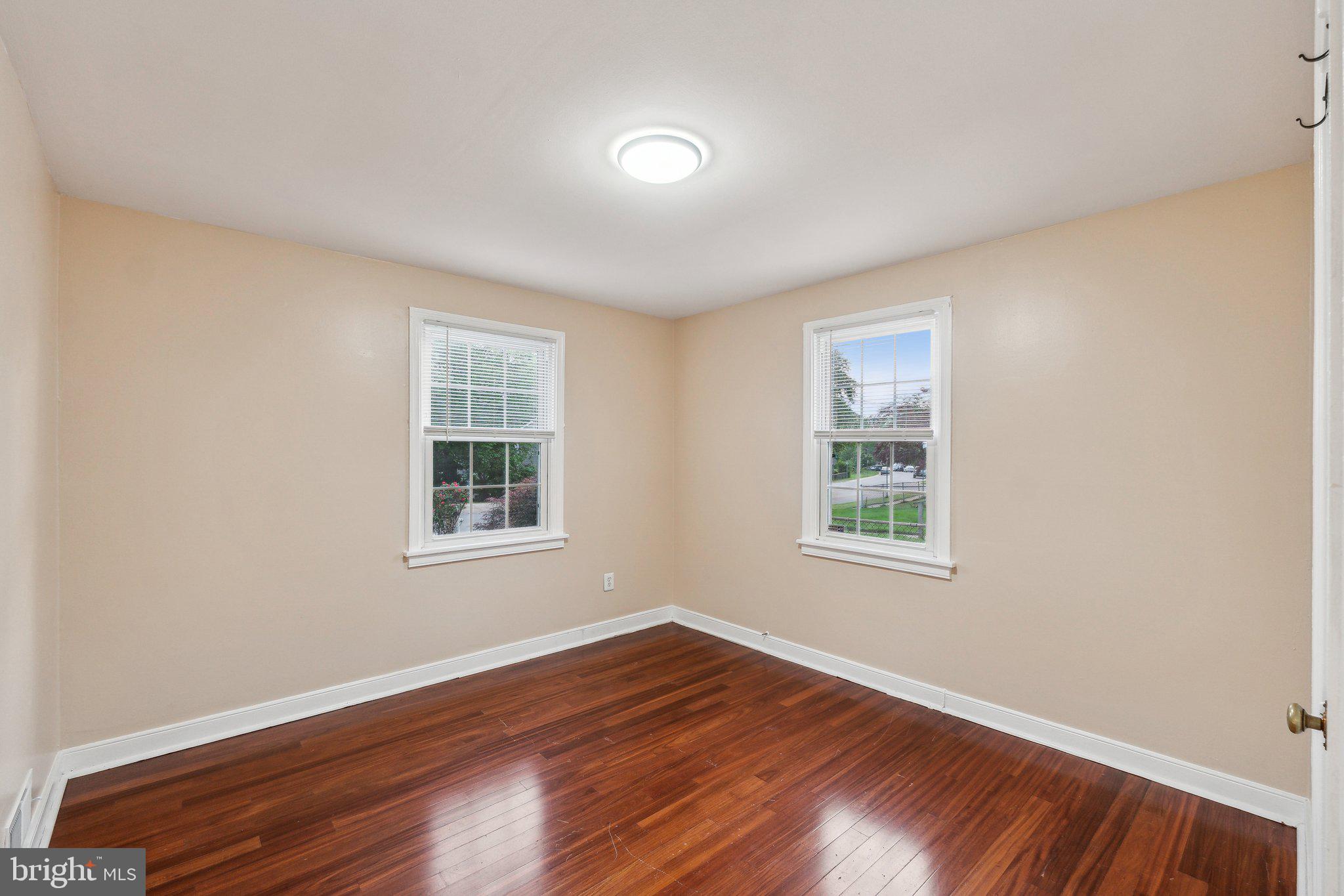 2621 Terrapin Road Silver Spring, MD 20906 - Photo 18 of 26 a view of an empty room with wooden floor and a window
