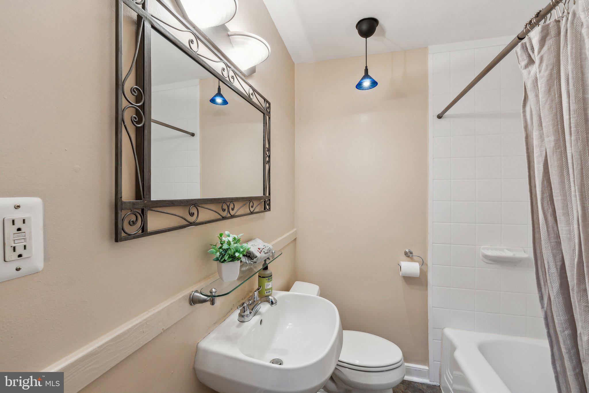 2621 Terrapin Road Silver Spring, MD 20906 - Photo 20 of 26 a bathroom with a toilet a sink and a mirror