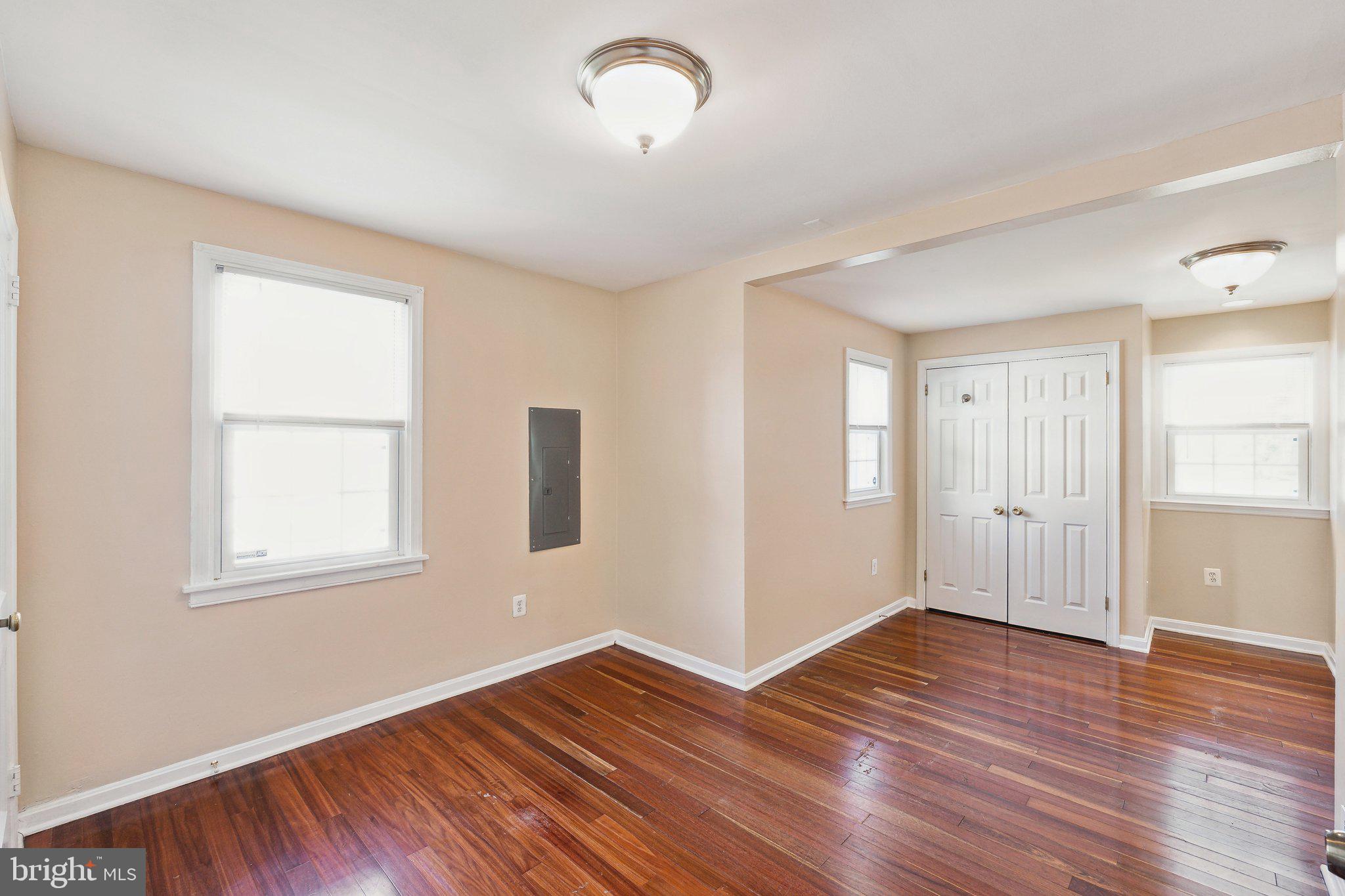 2621 Terrapin Road Silver Spring, MD 20906 - Photo 21 of 26 an empty room with wooden floor and windows