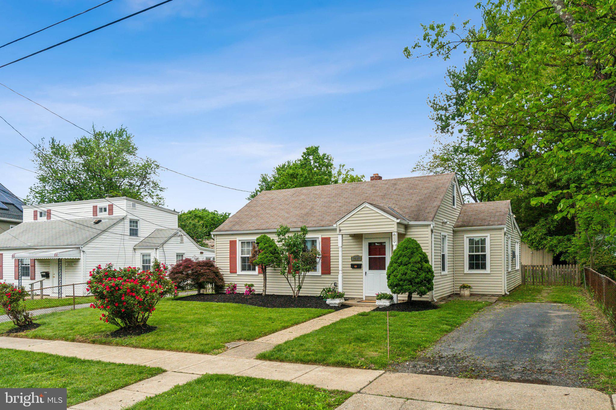 2621 Terrapin Road Silver Spring, MD 20906 - Photo 5 of 26 a view of a white house with a yard and potted plants