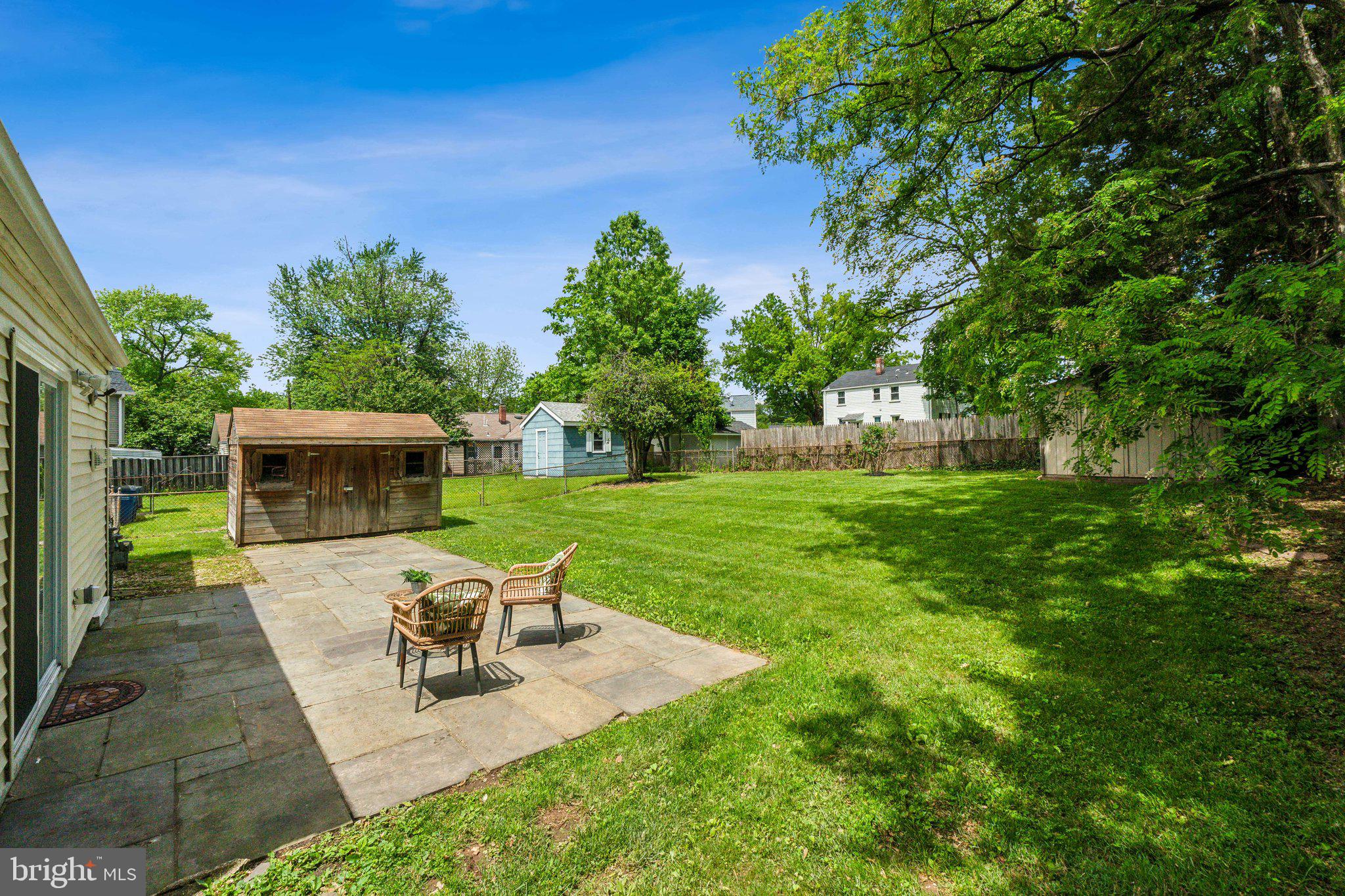 2621 Terrapin Road Silver Spring, MD 20906 - Photo 7 of 26 a view of a patio with table and chairs potted plants and a palm tree