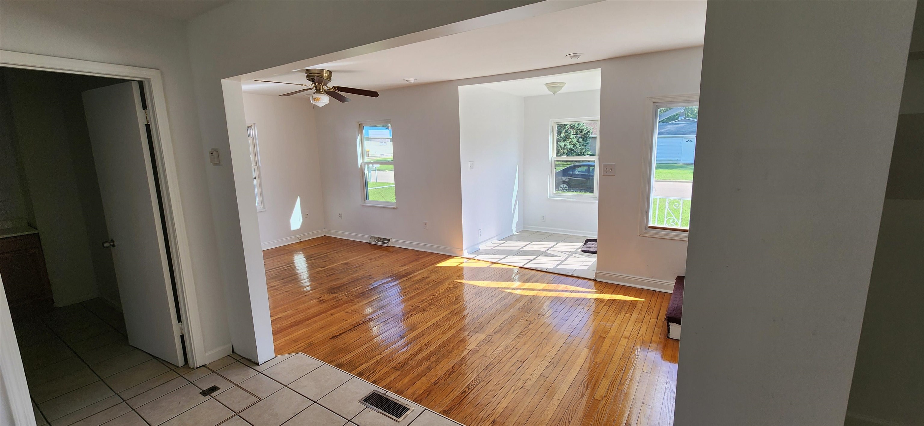 304 Wilshire Drive Machesney Park, IL 61115 - Photo 4 of 6 an empty room with wooden floor and windows