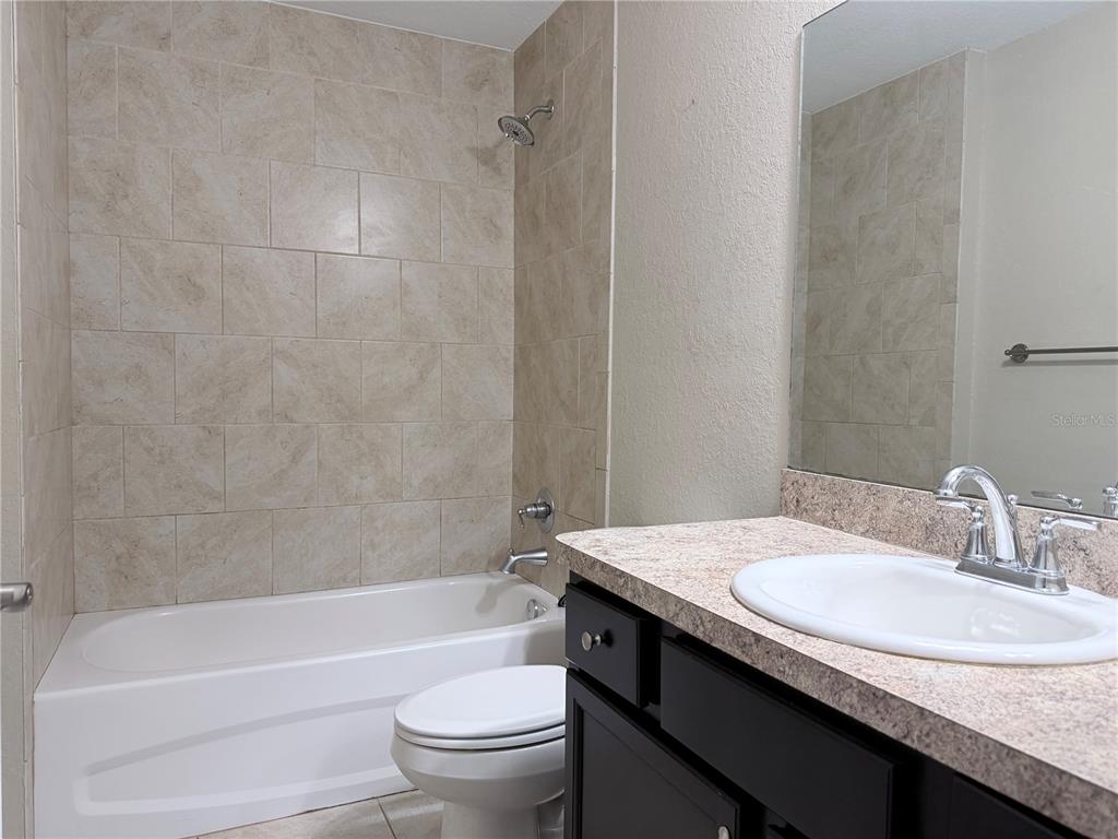 14445 Southwest 22nd Place Ocala, FL 34481 - Photo 11 of 11 a bathroom with a granite countertop sink toilet and bathtub