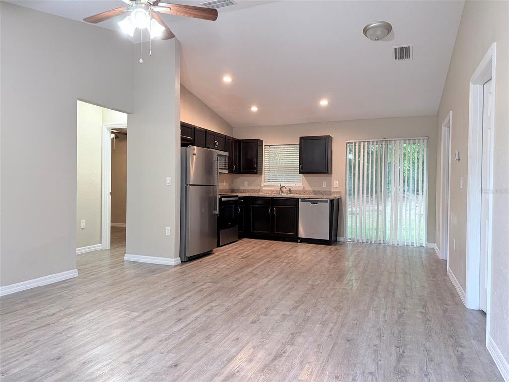 14445 Southwest 22nd Place Ocala, FL 34481 - Photo 2 of 11 a view of kitchen with kitchen island wooden floor and refrigerator