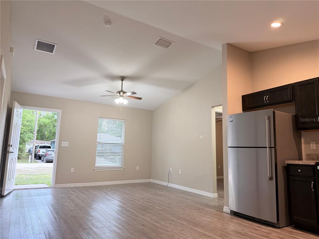 14445 Southwest 22nd Place Ocala, FL 34481 - Photo 5 of 11 a view of a kitchen with a refrigerator and a stove top oven