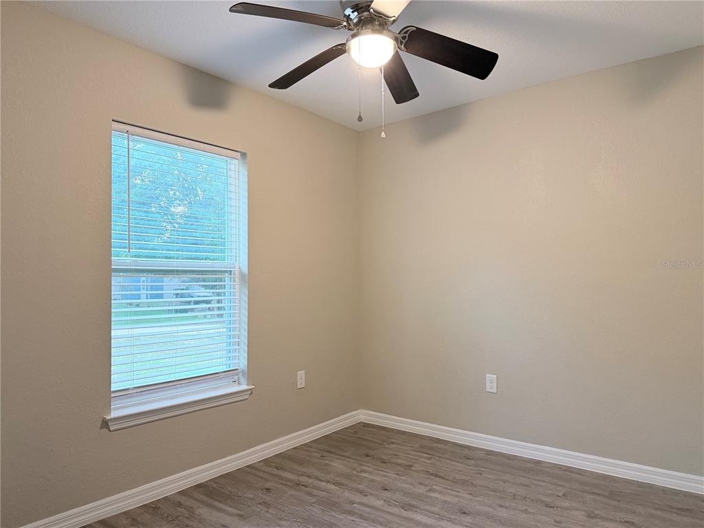 14445 Southwest 22nd Place Ocala, FL 34481 - Photo 10 of 11 wooden floor in an empty room with a window