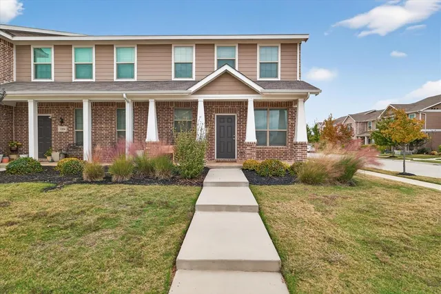 a front view of a house with yard