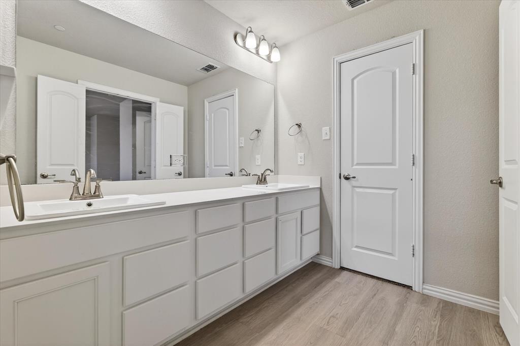 2200 Davenport Drive Denton, TX 76207 - Photo 15 of 23 a bathroom with a double vanity sink and mirror