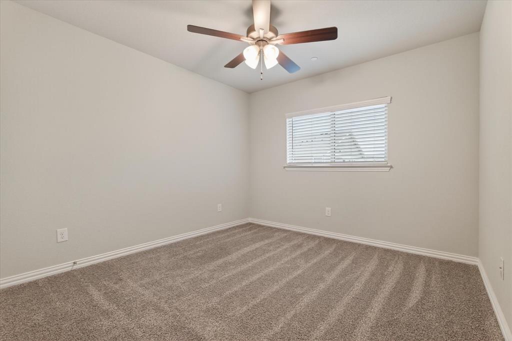 2200 Davenport Drive Denton, TX 76207 - Photo 18 of 23 an empty room with a window and a fan